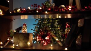 Tree of Christmas over a blurred decorated bookshelf in living room